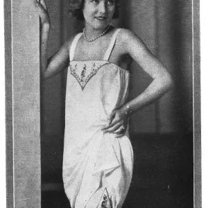 Model wearing embroidered chemise over embroidered long knickers and stockings Date: 1920s Model wearing embroidered chemise over embroidered long knickers and stockings Date: 1920s