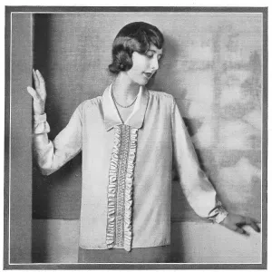A model wearing a loose blouse with a ruffle. Date: 1920s A model wearing a loose blouse with a ruffle. Date: 1920s