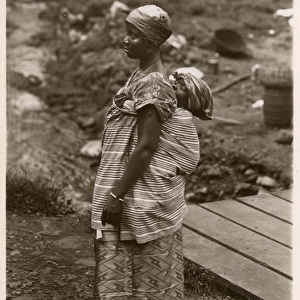 Mother carries her baby, Freetown, Sierra Leone, West Africa