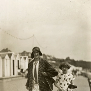 Mother and daughter at the seaside - bucket and spade