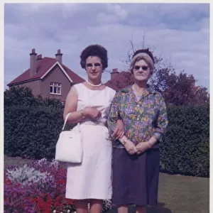 Mother and Grandmother in a neat suburban back garden