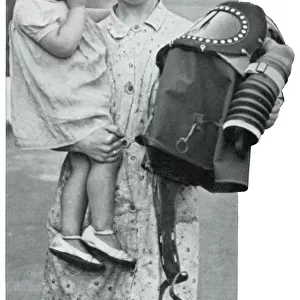 Mother holding baby and specialised gas mask, Sept 1939