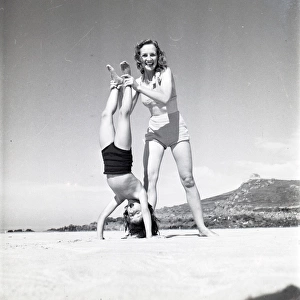 Mother and son doing handstand