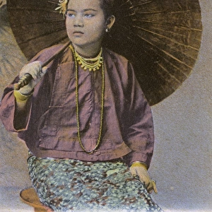 Myanmar - A Burmese girl with large open paper parasol
