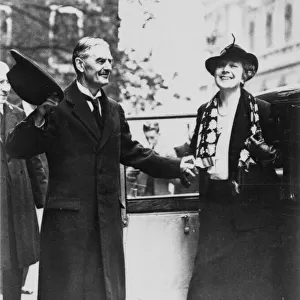Neville Chamberlain helping his wife out of a car