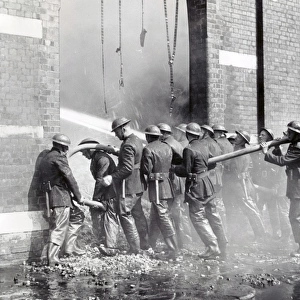 NFS (London Region) firemen with hose lines, WW2
