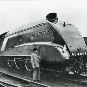 Nigel Gresley standing alongside his A4 class steam engine Nigel Gresley standing alongside his A4 class steam engine