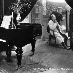 Nude model on a break plays a piano