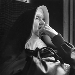 Nun sitting looking thoughtful