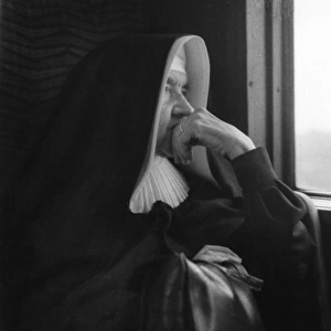 Nun sitting by a window