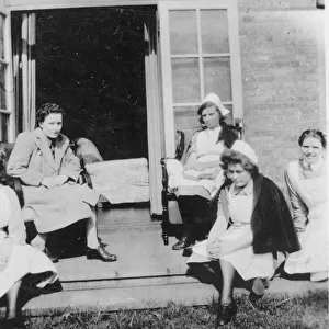 Four nurses and woman in on steps