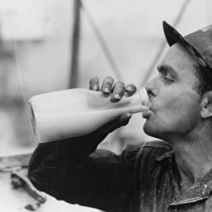 Oil field worker drinking a bottle of milk at lunch, Kilgore