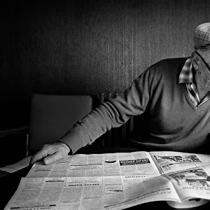 Old man reading newspaper in cafe, Le Monastier-sur-Gazeille
