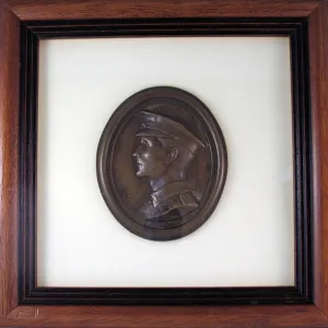 Oval plaque in relief depicting the head of a young Tommy