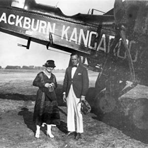 Two passengers pose alongside a Blackburn RT1 Kangaroo