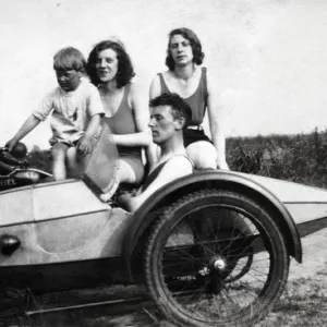 Four people on a 1929 Ariel motorcycle & sidecar