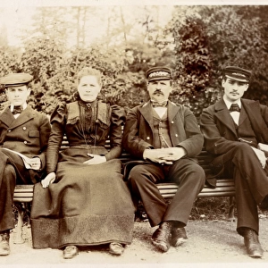 Four people on a bench in a garden