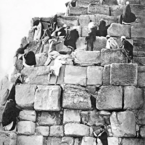 People climbing a pyramid, Egypt