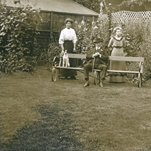 Three people with a dog in a garden