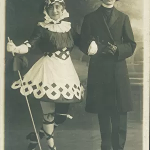Two people in fancy dress. The girl on the left is in a fanciful Pierrot type outfit