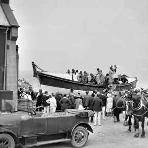 People in and around a lifeboat