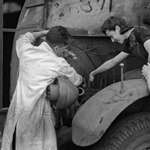 People repairing a vehicle