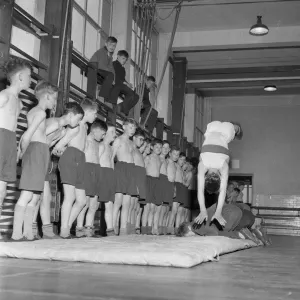 1950s Gymnasium Print: Boy Performs Acrobatic Feat 1950s Gymnasium Print: Boy Performs Acrobatic Feat