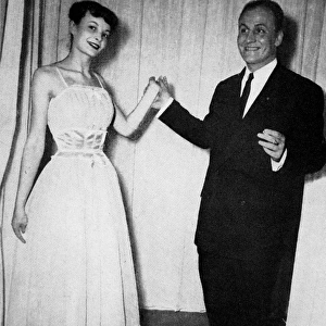 Pierre Balmain with one of his designs, 1948