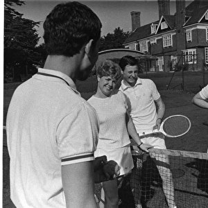 Four police officers playing mixed doubles tennis