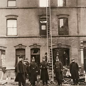 Policemen guarding house in Sidney Street, East London