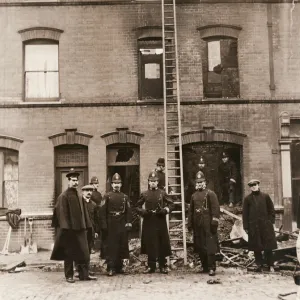 Policemen guarding house in Sidney Street, East London