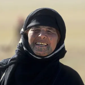 Portrait of middle aged Syrian Bedouin woman with tattoos