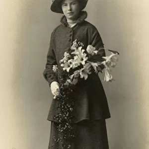 Pretty Young lady holding an elaborate bouquet