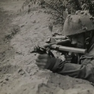 Pte J Connington of Selby, Yorks, in action with Sten gun