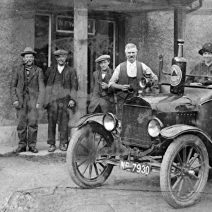 Publican and customers outside pub, with a Bass Brewery car