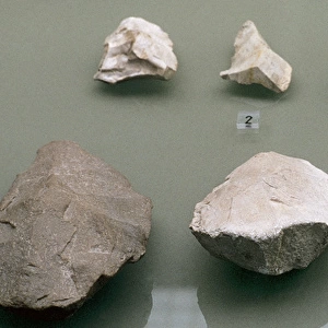 Quartzite cleaver and bifaces. Middle Paleolithic or Mouste