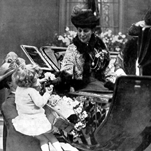Queen Alexandra receiving a rose from a child, London, 1925