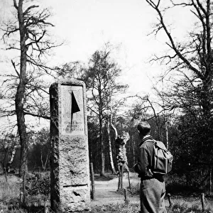A rambler in plus fours reads the inscription on the sundial monument to daylight saving