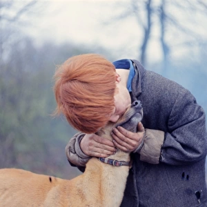 Red-haired gipsy boy with a dog