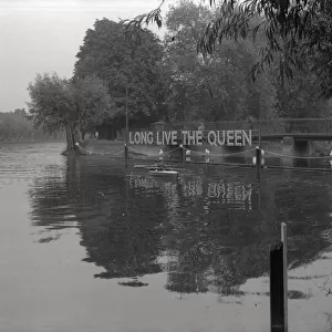 A riverbank decorated with Long Live the Queen - Coronation