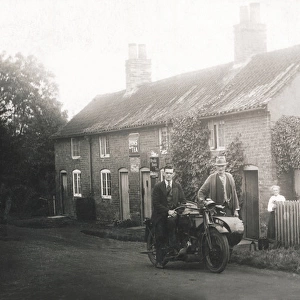 Rural scene showing veteran motorcycle combination & cottage