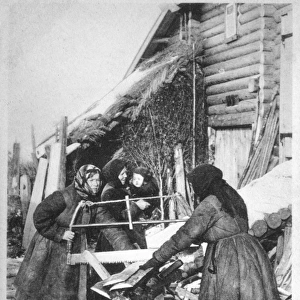Russian peasant women sawing wood