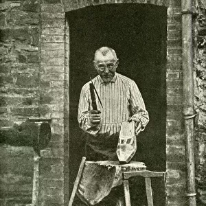 Sabot maker working at his cottage door, Belgium