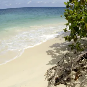 Sand beach of volcanic Tioman Island and sea at high tide