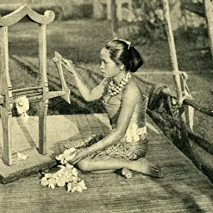Sea Dayak woman making thread, Borneo, SE Asia