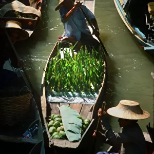 Seller paddles his boat into Damnoen Saduak floating market