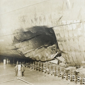 Ship in dry dock with damaged hull