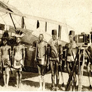 Shulluk warriors pose by Alan Cobhams aeroplane, Sudan