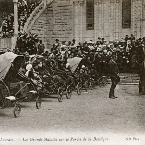 The sick in Bath chairs by the Basilica, Lourdes, France