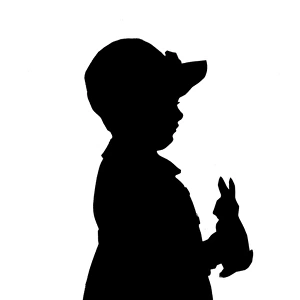 Silhouette of boy with toy rabbit